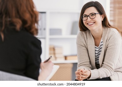 Happy woman during successful psychotherapy with counselor at clinic