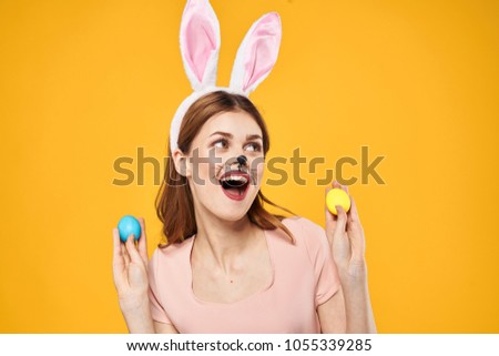  happy woman with easter eggs on a yellow background                              