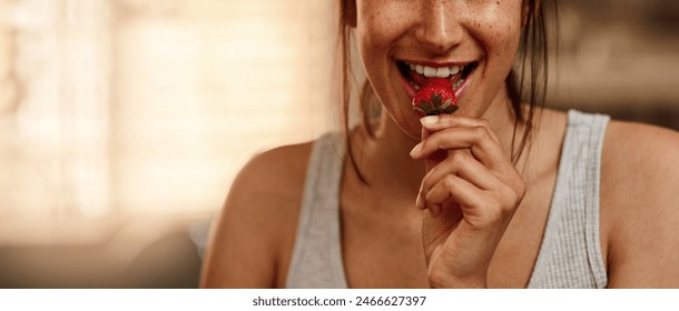 Happy, woman and eating strawberry in kitchen for nutrition, health and wellness in home. Female person, smile and fruit for organic snack in summer with diet, detox and vegan food for breakfast - Powered by Shutterstock