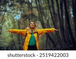 
Happy Woman Enjoying the Forest During Spring Season 
Carefree tourist relaxing outdoors feeling happiness and nature connection 
