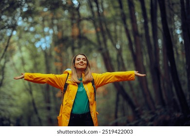 
Happy Woman Enjoying the Forest During Spring Season 
Carefree tourist relaxing outdoors feeling happiness and nature connection 
