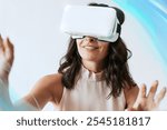 Happy woman enjoying a vr headset. Woman VR headset device, blue innovative VR technology hologram overlay, high-tech futuristic virtual reality technology concept.