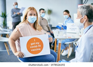 Happy Woman With Face Mask Getting Vaccinated Against Coronavirus And Holding Supportive Placard With 