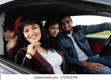 The Happy Woman With Family In The Car