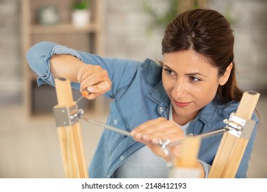 Happy Woman Is Fixing Broken Lamp