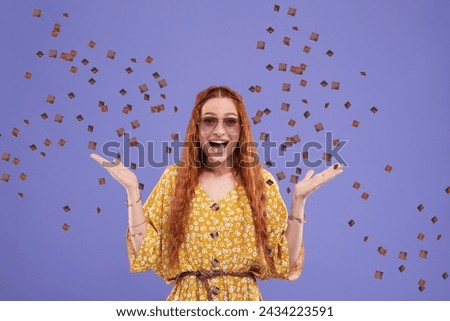 Happy woman and flying confetti on blue violet background