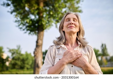 Happy woman folded hands on her chest