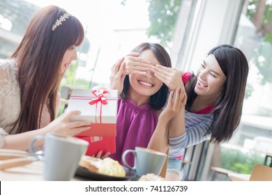 Happy Woman Friends Feel Surprise With Gift In Restaurant