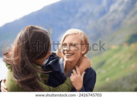 Happy woman, friends and laughing with hug for funny joke, humor or bonding together in nature. Female person with smile for embrace, care or support on hiking holiday, weekend or outdoor travel