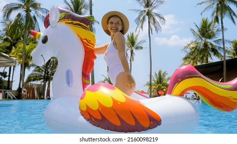 Happy Woman Fun In Swimming Pool With Inflatable Swim Tube, Enjoying Summer Day, Getting Sun Tan And Relaxing In Modern Tropical Resort. Holidays, Summer Vacation And Celebrating Trip Concept.