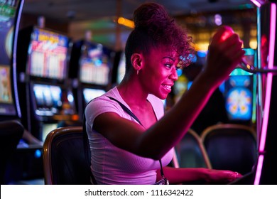 Happy Woman Gambling At Casino Playing Slot Machine