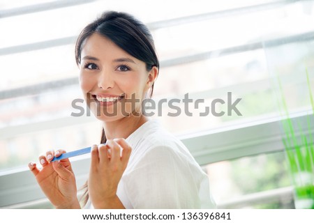 Similar – Woman filing nails in colored background