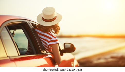 Happy Woman Girl Goes To Summer Travel Trip In The  Car
