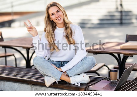 Similar – Blonde young caucasian woman smiling on steps