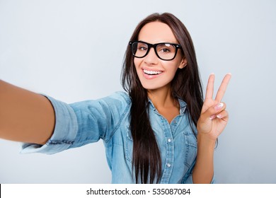 Happy Woman In Glasses With Beaming Smile Making Selfie And Showing V-sign