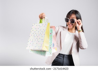 Happy Woman With Glasses Confident Shopper Smiling Holding Online Shopping Bags Colorful Multicolor, Portrait Excited Asian Young Female Purchase Studio Shot Isolated On White Background, Fashion Sale