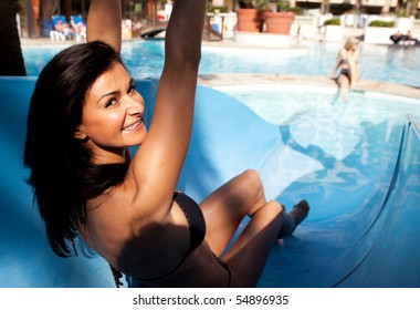 A Happy Woman Going Down A Water Slide