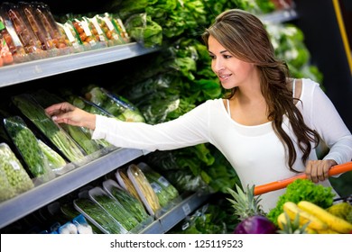 Happy Woman Grocery Shopping At The Supermarket