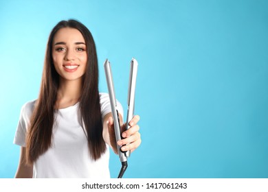 Happy Woman With Hair Iron On Color Background. Space For Text