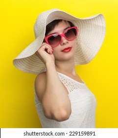 Happy woman in hat and sun glasses