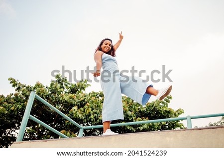 Similar – Happy women jumping in front of garden fence