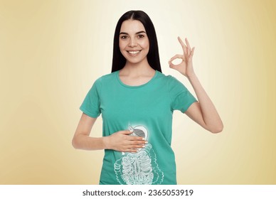 Happy woman with healthy digestive system on light yellow background. Illustration of gastrointestinal tract - Shutterstock ID 2365053919