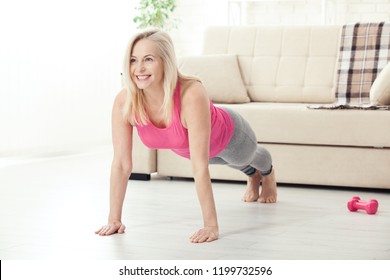 Happy woman in her 50s stretching for exercise. Joy of life and freedom in movement, concept. Selective focus. - Powered by Shutterstock