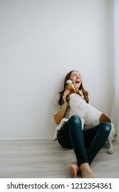 Happy woman with her dog at home