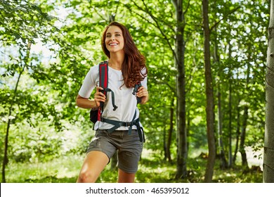 Happy woman hiking in the woods