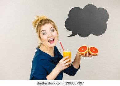 Happy woman holding fresh orange grapefruit juice. Healthy fruit drink smoothies concept, black thinking or speech bubble next to her. - Shutterstock ID 1308837307