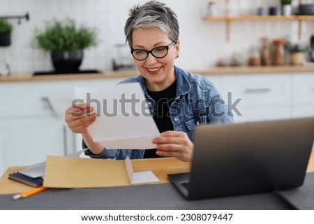 Happy woman holding paper with good news, payout.