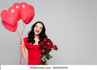 happy woman holding red heart-shaped balloons and roses isolated on grey - Powered by Shutterstock