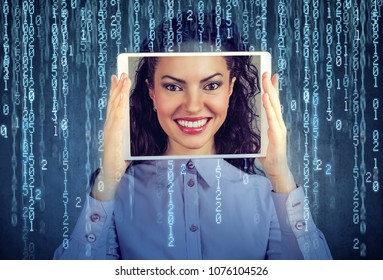 Happy woman holding tablet with her face displayed on a screen isolated on binary code background 