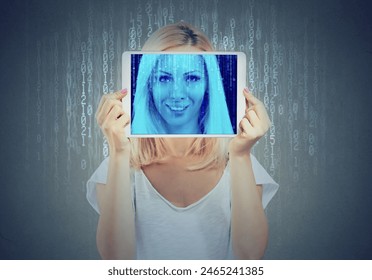 Happy woman holding tablet with her face displayed on a screen with binary code 