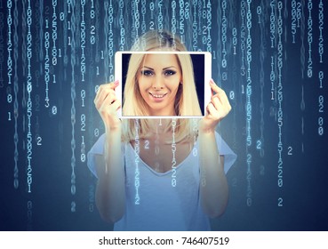Happy woman holding tablet with her face displayed on a screen isolated on binary code background  - Powered by Shutterstock - Get 15% off with code: PIKWIZARD15