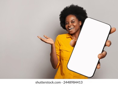 Happy woman holds empty blank screen display phone. Female with smartphone