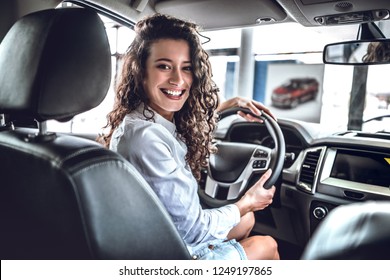 Happy Woman Inside Car In Auto Show Or Salon.