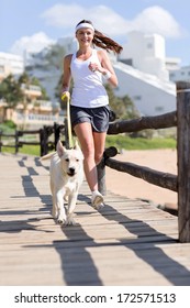 Happy Woman Jogging With Her Dog