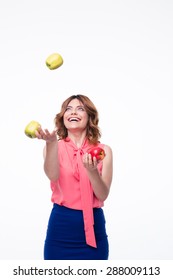 Happy woman juggles with apples isolated on a white background