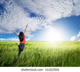 Happy Woman Jump In Grass Fields And Blue Sky