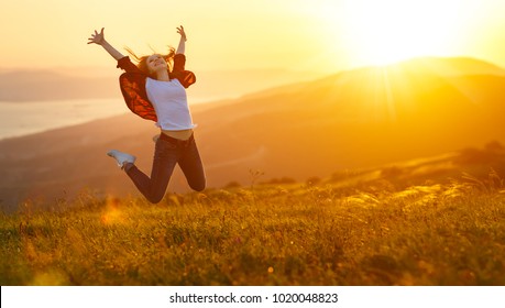 Happy woman jumping and enjoying life in field at sunset in mountains - Shutterstock ID 1020048823