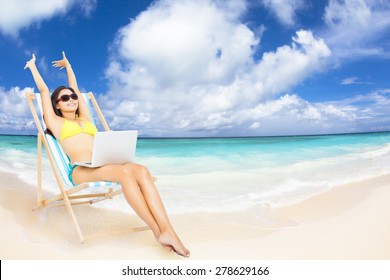 Happy Woman With  Laptop On The Tropical Beach