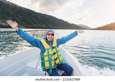 Happy Woman In A Life Jacket Sail In A Boat On A Mountain Lake