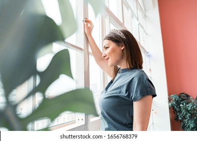 Happy Woman Looking Through Window And Smiling. Beginning Of New Day. Resolution Of New Life. Today Is A New Beginning. Inspiration And Optimism