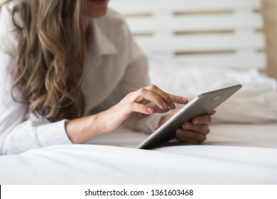 Happy woman lying on the bed with tablet computer  - Shutterstock ID 1361603468