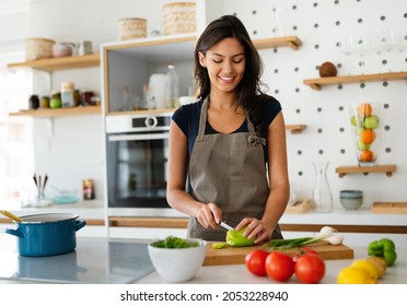 Happy Woman Making Healthy Food In Kitchen.