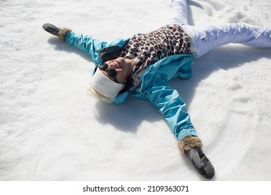 Happy Woman Making Snow Angels