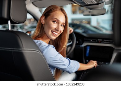 Happy Woman New Car Owner Sitting In Driver Seat