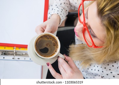 Happy Woman At Office Drinking Hot Coffee Or Tea Enjoying Her Break Time During Work. Job Relax.