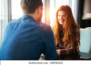 Happy woman on a first date with handsome man showing emotions
